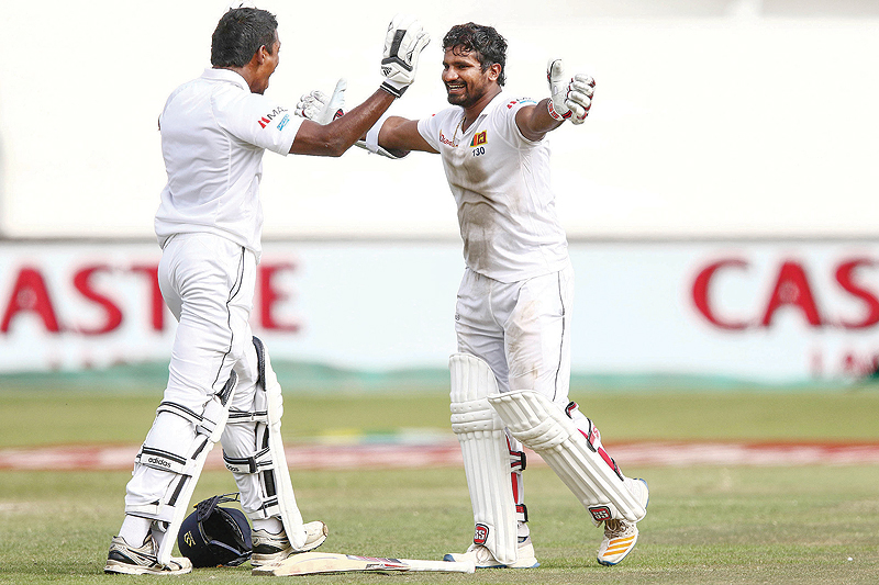 DURBAN: Sri Lanka’s Kusal Perera (R) celebrates the victory after hittting the winning runs with Vishawa Fernando (L) during the fourth day of the first Cricket Test between South Africa and Sri Lanka at the Kingsmead Stadium in Durban yesterday. — AFP