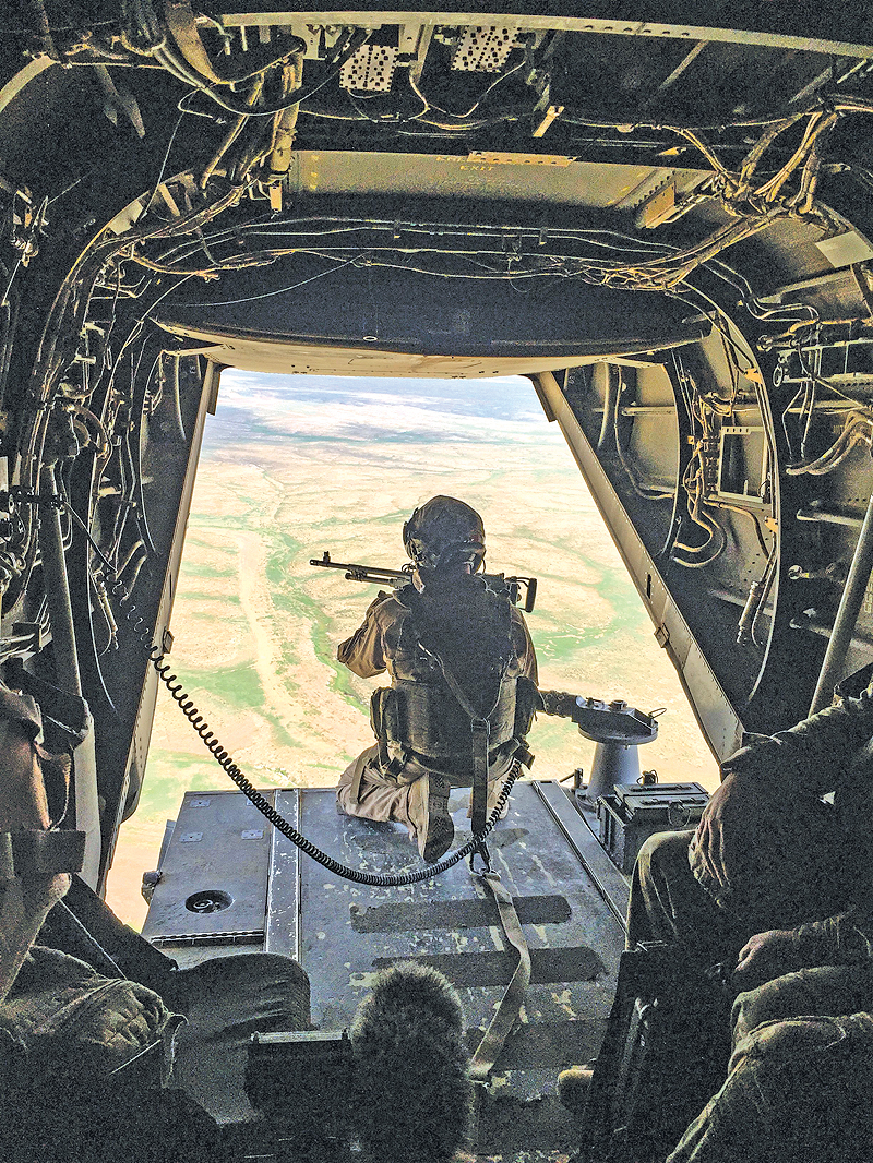 AL-QAIM: A gunner mans a machine gun at the back of a US Marine Corps V-22 Osprey flying near a French artillery base near Al-Qaim in Iraq’s western Anbar province opposite Syria’s Deir Ezzor region. — AFP