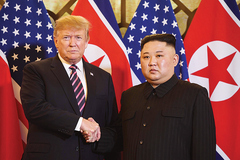 HANOI: US President Donald Trump shakes hands with North Korea's leader Kim Jong Un before a meeting at the Sofitel Legend Metropole hotel yesterday. - AFP 