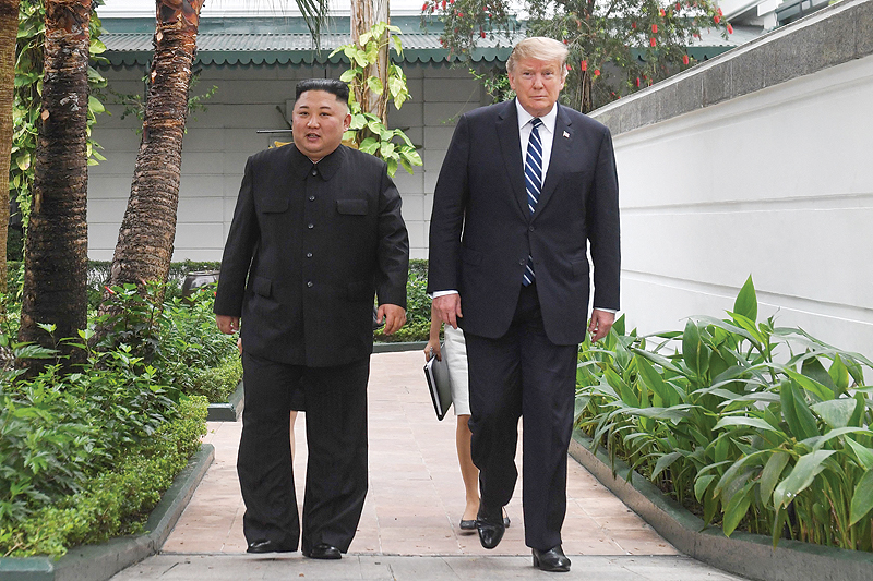 HANOI: US President Donald Trump (right) walks with North Korea’s leader Kim Jong Un during a break in talks at the second US-North Korea summit yesterday. — AFP