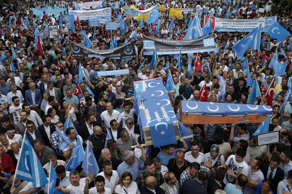 In this Saturday, July 4, 2015 file photo, Uighurs living in Turkey and their supporters, some carrying coffins representing Uighurs who died in China’s far-western Xinjiang Uighur region, chant slogans as they stage a protest in Istanbul, against what they call as oppression by Chinese government to Muslim Uighurs in the province. In a statement Saturday Feb. 9, 2019, Turkey’s foreign ministry has called China’s treatment of its minority Uighurs “a great cause of shame for humanity.” The Foreign Ministry spokesman Hami Aksoy said it’s “no longer a secret” that China has arbitrarily detained more than a million Uighurs in “concentration camps.” AP PHOTO