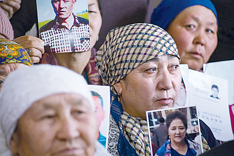 ALMATY: Petitioners with relatives missing or detained in Xinjiang hold up photos of their loved ones during a press event at the office of the Ata Jurt rights group in Almaty, Kazakhstan. —AFP