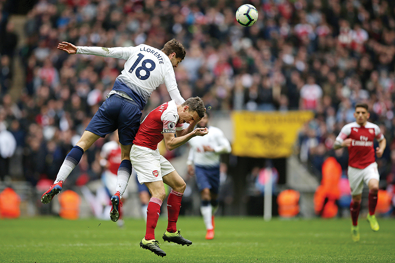 LONDON: Tottenham Hotspur’s Spanish striker Fernando Llorente (L) vies with Arsenal’s French defender Laurent Koscielny during the English Premier League football match between Tottenham Hotspur and Arsenal at Wembley Stadium in London, yesterday. — AFP