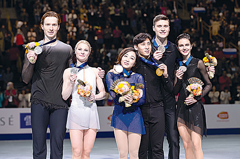 SAITAMA: (From L to R) Russia's Vladimir Morozov, Evgenia Tarasova, China's Wenjing Sui, Cong Han and Russia's Natalia Zabiiako, Alexander Enbert pose on the podium during the medal ceremony after Pairs free Program during the world figure skating championships in Japanese city of Saitama yesterday. - AFP
