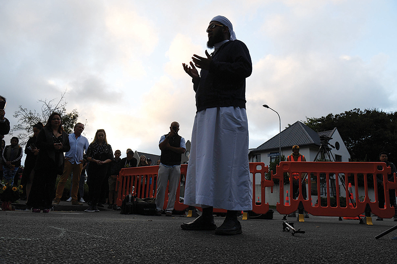 CHRISTCHURCH: Mulim cleric Mufti Zeeyad Ravat leads a prayer near the Al Noor mosque in Christchurch yesterday. New Zealand Prime Minister Jacinda Ardern vowed never to utter the name of the twin-mosque gunman as she opened a somber session of parliament with an evocative ‘as salaam alaikum’ message of peace to Muslims.— AFP