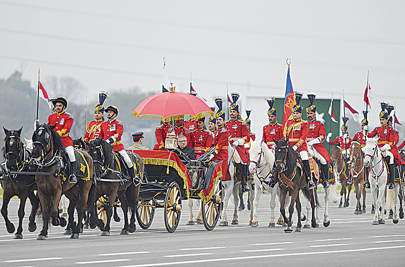 ISLAMABAD: Pakistani President Arif Alvi (center) arrives at the Pakistan Day parade in Islamabad yesterday. —AFP