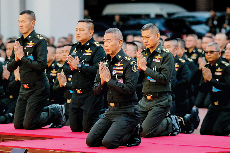 BANGKOK: Royal Thai Army Commander in Chief Apirat Kongsompong (center) with other senior officers kneels before the statue of the late King Chulalongkorn, during an oath ceremony at the army headquarters in Bangkok yesterday ahead of the March 24 general election. —AFP