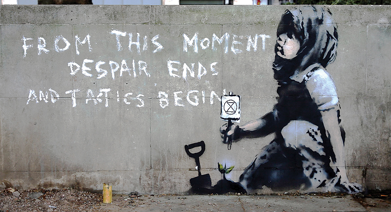 Graffiti artwork, suspected to have been created by the British street artist Banksy, is pictured opposite the environmental protest group Extinction Rebellion’s camp at Marble Arch in London. — AFP