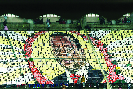 An image of President Emmerson Mnangagwa is formed by hundreds of people during the celebration of Zimbabwe's 39th Independence Day anniversary at the country's National Sports Stadium on April 18, 2019. (Photo by Jekesai NJIKIZANA / AFP)