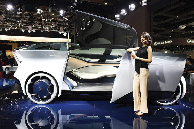 SHANGHAI: A model stands beside an Icona Nucleus self-driving electric vehicle concept on the opening day of the Shanghai Auto Show. — AFP