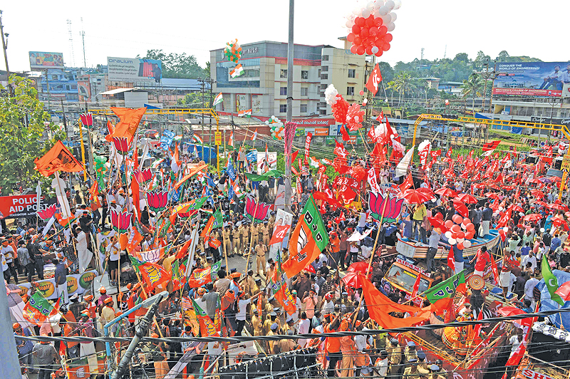 PATHANAMTHITTA: Indian supporters of the Bharatiya Janata Party (BJP), National Congress Party and Communist Party of India celebrate in front of each other during the final day of election campaigning in the city of Pathanamthitta, in the south Indian state of Kerala. — AFP