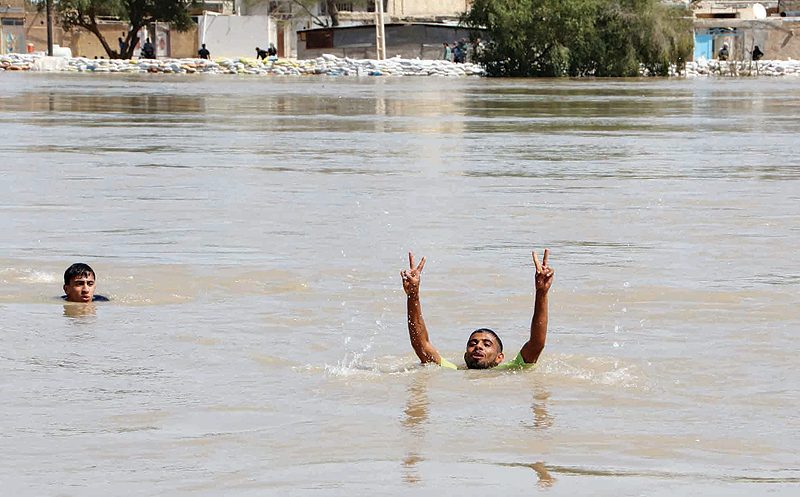 OAMIDIYEH, Iran : Iranians take Swim in the flooded Karkheh river in Omidiyeh, in Iran’s Khuzestan province. Authorities ordered tens of thousands of residents of the southwestern Iranian city of Ahvaz to evacuate immediately as floodwaters entered the capital of oil-rich Khuzestan province, state television reported. — AFP