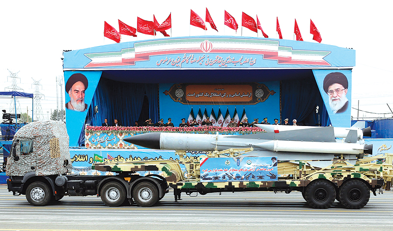 TEHRAN: A Iranian military truck carrying a missile drives in front of the officials’ stand during a military parade marking the annual National Army Day in Tehran yesterday. — AFP