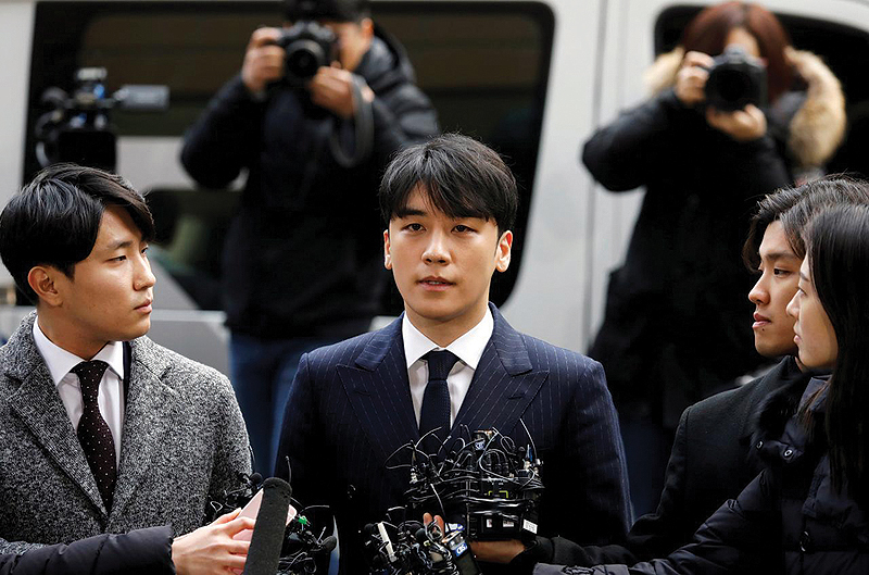 Seungri, a member of South Korean K-pop band Big Bang, arrives to be questioned over a sex bribery case at the Seoul Metropolitan Police Agency in Seoul, South Korea, yesterday. — Reuters