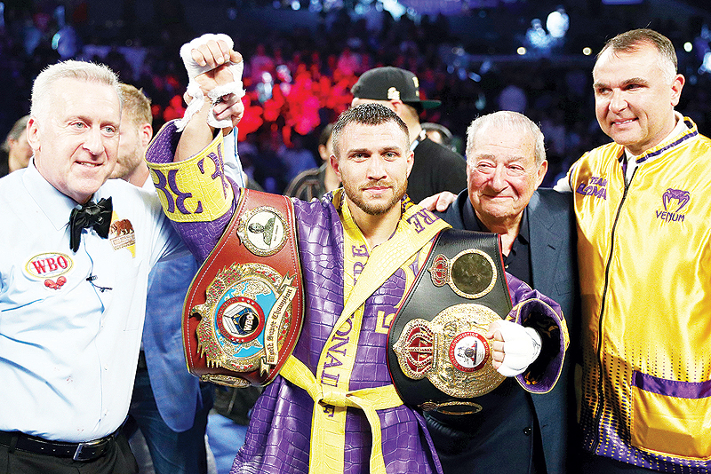 LOS ANGELES: Vasiliy Lomachenko celebrates defending his WBA/WBO lightweight titles after knocking out Anthony Crolla at Staples Center in Los Angeles, California. — AFP