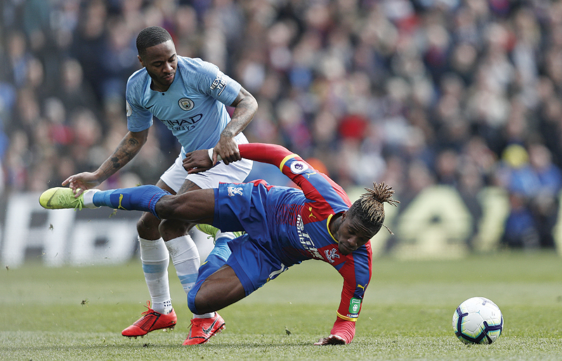 LONDON: Manchester City's English midfielder Raheem Sterling (L) vies with Crystal Palace's Ivorian striker Wilfried Zaha (R) during the English Premier League football match between Crystal Palace and Manchester City at Selhurst Park in south London yesterday. - AFP