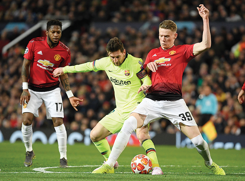 MANCHESTER: Barcelona’s Argentinian forward Lionel Messi (C) vies with Manchester United’s English midfielder Scott McTominay during the UEFA Champions league first leg quarter-final football match between Manchester United and Barcelona at Old Trafford. — AFP