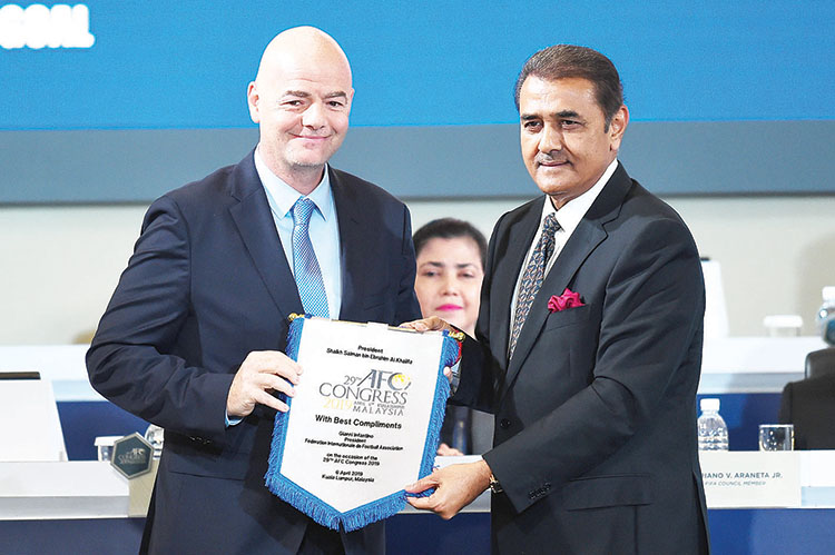 FIFA president Gianni Infantino receives pennant from AFC senior vice president Praful Patel during the Asian Football Confederation (AFC) Congress 2019 in Kuala Lumpur on April 6, 2019. (Photo by SADIQ ASYRAF / AFP)