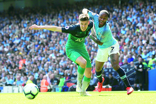Tottenham Hotspur's Argentinian defender Juan Foyth (L) vies with Manchester City's English midfielder Raheem Sterling during the English Premier League football match between Manchester City and Tottenham Hotspur at the Etihad Stadium in Manchester, north west England, on April 20, 2019. (Photo by Lindsey PARNABY / AFP) / RESTRICTED TO EDITORIAL USE. No use with unauthorized audio, video, data, fixture lists, club/league logos or 'live' services. Online in-match use limited to 120 images. An additional 40 images may be used in extra time. No video emulation. Social media in-match use limited to 120 images. An additional 40 images may be used in extra time. No use in betting publications, games or single club/league/player publications. /