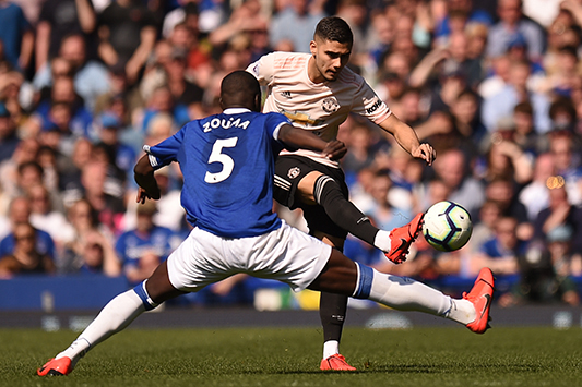 LIVERPOOL: Manchester United's Belgian-born Brazilian midfielder Andreas Pereira (R) plays the ball past Everton's French defender Kurt Zouma (L) during the English Premier League football match between Everton and Manchester United at Goodison Park in Liverpool yesterday. - AFP