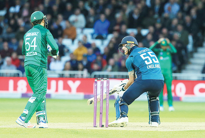 NOTTINGHAM: England's Ben Stokes (R) plays a shot as Pakistan's Sarfraz Ahmed looks on during the fourth One Day International (ODI) cricket match between England and Pakistan at Trent Bridge in Nottingham. - AFP