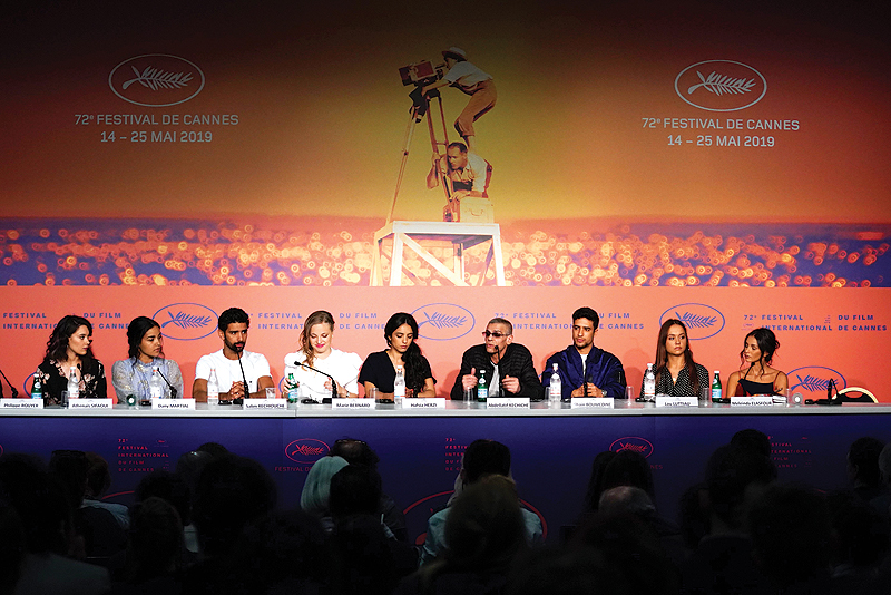 (From left) French actress Athenais Sifaoui, French actress Dany Martial, French actor Salim Kechiouche, French actress Marie Bernard, French actress Hafsia Herzi, French-Tunisian film director Abdellatif Kechiche, French actor Shain Boumedine, French actress Lou Luttiau and French actress Meleinda Elasfour attend a press conference for the film “Mektoub, My Love : Intermezzo” at the 72nd edition of the Cannes Film Festival in Cannes, southern France. — AFP