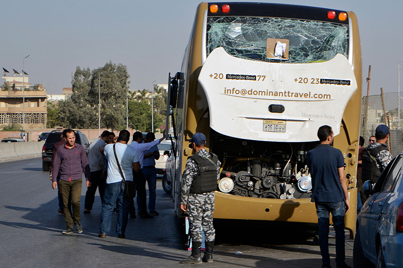 GIZA: Photo shows a bus damaged during a bomb blast near Egypt's famed Giza pyramids. A bomb blast hit a tourist bus wounding at least 17 people, including South Africans, in the latest blow to the country's tourism industry. - AFP  