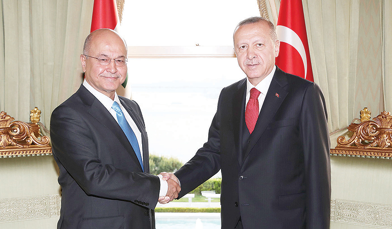ANKARA: In this handout photograph President of Turkey Recep Tayyip Erdogan, right, shakes hands with President of Iraq Barham Salih at a meeting at Vahdettin Pavilion in Istanbul. — AFP