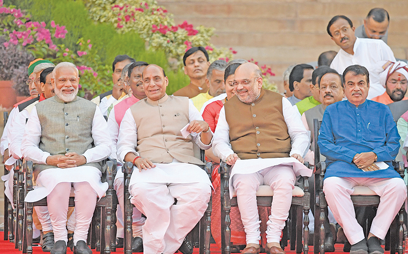 NEW DELHI: Narendra Modi, left, looks on as he sits next to Bharatiya Janata Party President Amit Shah, second right, and Minister of Home Affairs of India Rajnath Singh, second left, before Modi’s swearing-in ceremony as Indian Prime Minister at the President house in New Delhi. — AFP