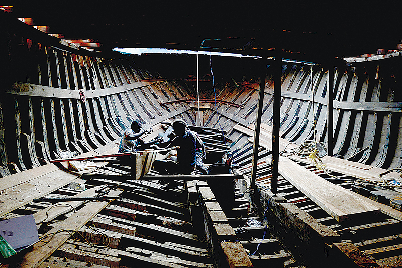 CHENNAI: Indian workers carry out maintenance work on a boat at a fishing vessel construction yard during trawling ban period in Chennai.  India's farmers and business community complained publicly that they suffered a drop in their businesses. -AFP