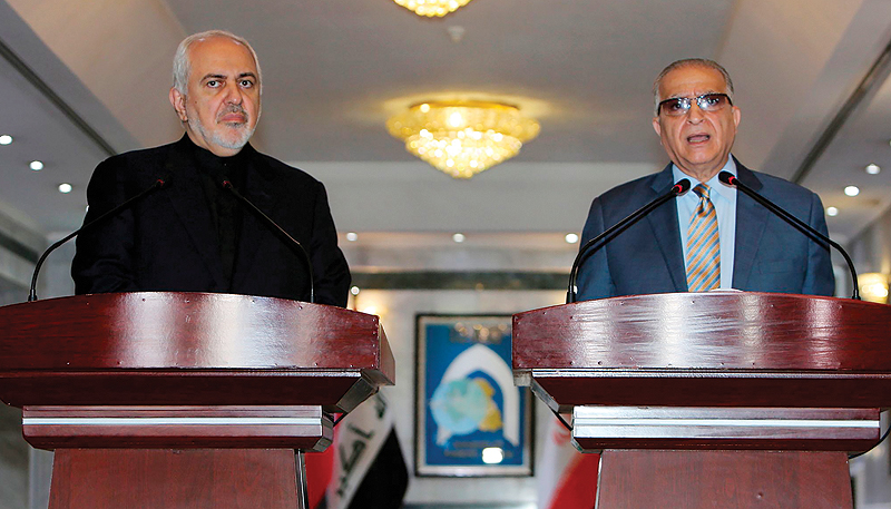 BAGHDAD: Iraqi Foreign Minister Mohammad Ali Al-Hakim (right) attends a press conference with Iran’s Foreign Minister Mohammad Javad Zarif in Baghdad yesterday. — AFP
