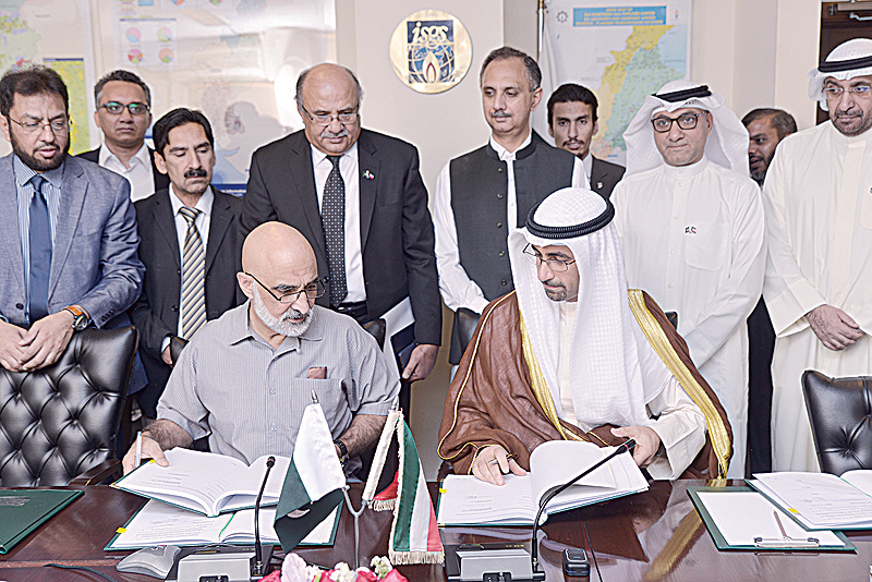 ISLAMABAD: Sheikh Nawaf Saud Nasir Al-Sabah and Mian Asad Hayaud Din sign the agreements.