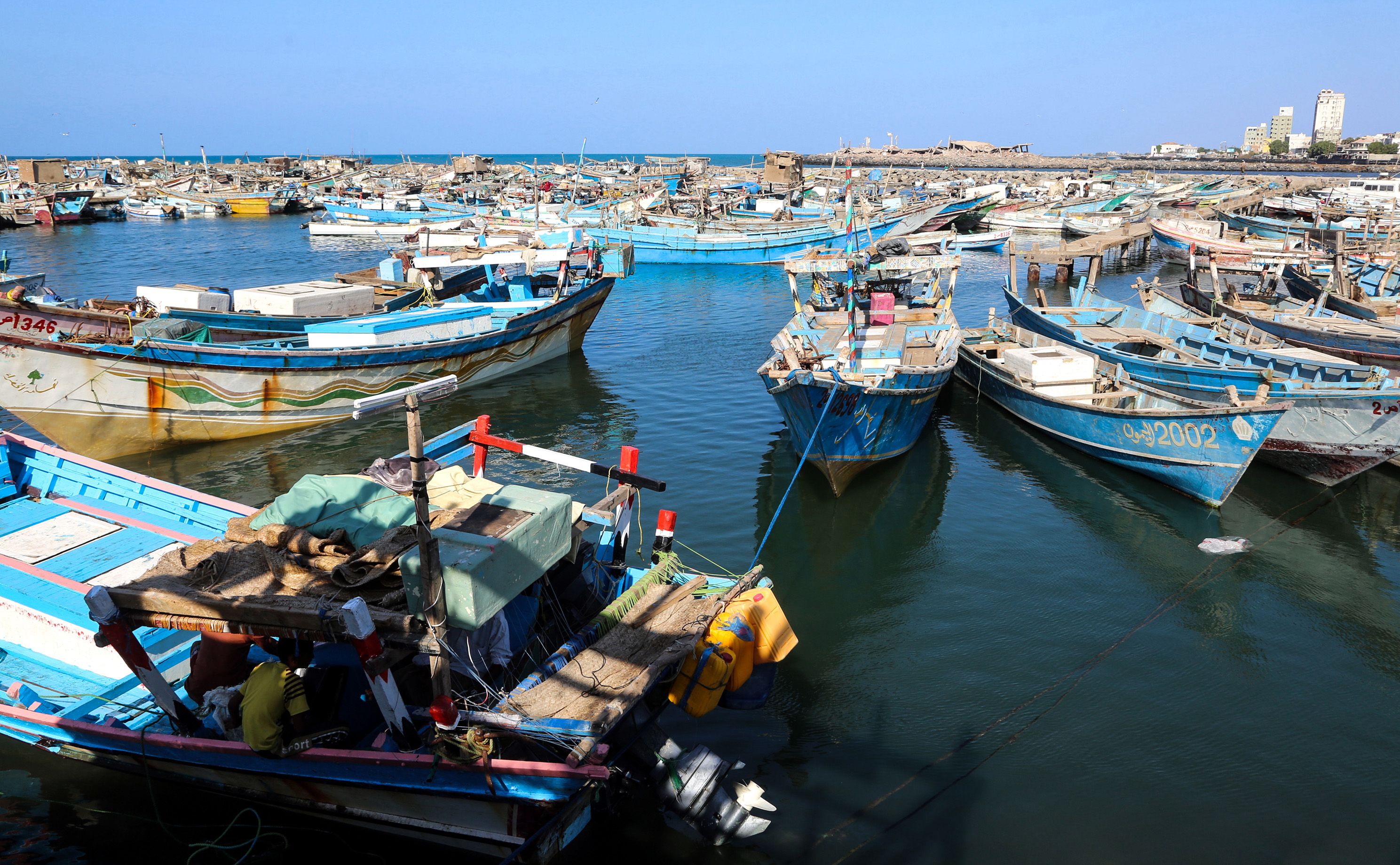 (FILES) This file picture taken on January 1, 2019 shows fishing boats moored to a dock in the embattled Yemeni Red Sea port city of Hodeida. - The United Nations and Yemen's Huthi rebels said the Huthis were to withdraw unilaterally from the three aid ports of Hodeida, Saleef, and Ras Issa starting May 11, 2019, in the first practical implementation of a ceasefire deal struck in Sweden in December. A senior pro-government official accused the rebels of faking the announced pullout without any monitoring by the UN and the government side. (Photo by - / AFP)