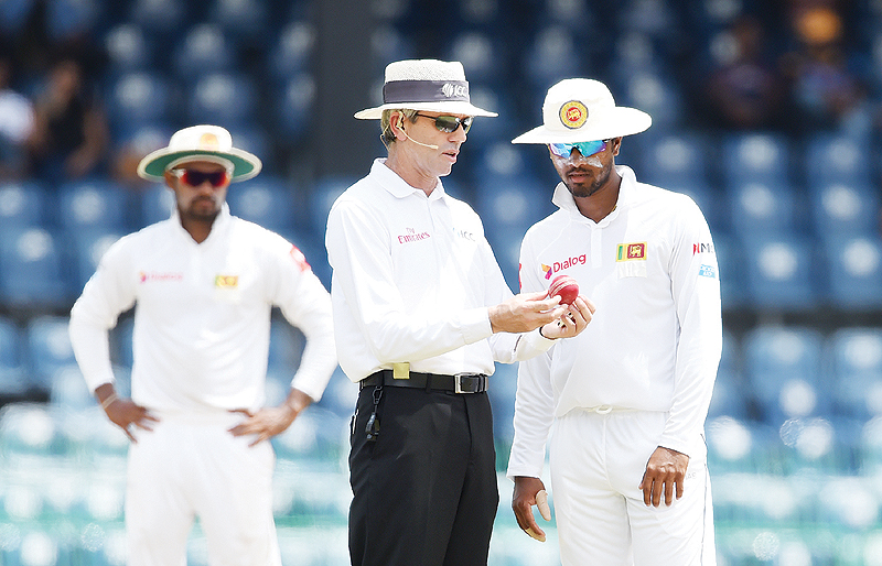 COLOMBO: File photo taken on July 17, 2017, umpire Nigel Llong (C) speaks with Sri Lankan cricket captain Dinesh Chandimal (R) during the fourth day of a Test match between Sri Lanka and Zimbabwe in Colombo. Indian Premier League umpire Nigel Llong has been reported to the national body for allegedly kicking a door after an altercation with Royal Challengers Bangalore skipper Virat Kohli, a press report said yesterday. — AFP