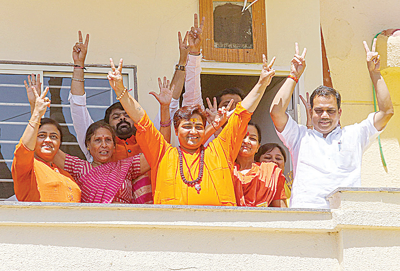 BHOPAL: Indian BJP candidate Pragya Singh Thakur gestures along with other BJP supporters on the vote results day for India's general election at her residence on May 23, 2019. - AFP 