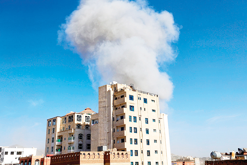SANAA: Smoke billows following an air strike in the Yemeni capital Sanaa yesterday. — AFP