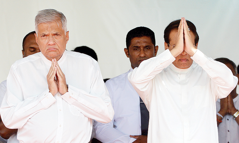 COLOMBO: Sri Lanka’s President Maithripala Sirisena (right) and Prime Minister Ranil Wickremesinghe attend a commemoration ceremony to mark the 26th anniversary of the assassination of Sri Lanka’s then-president Ranasinghe Premadasa in Colombo yesterday. — AFP