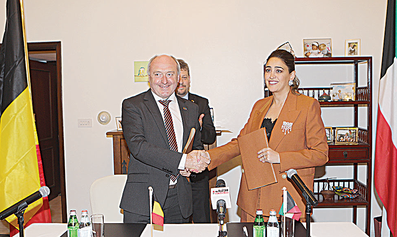 KUWAIT: Taiba Hospital CEO Lama Al-Fadala (right) and Hict CEO Jan Demey shake hands after signing the agreement. —Photos by Joseph Shagra