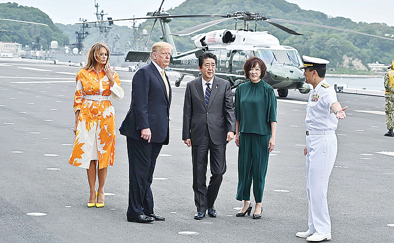 YOKOSUKA, Japan: US President Donald Trump, First Lady Melania Trump, Japan’s Prime Minister Shinzo Abe and his wife Akie arrive onboard Japan Maritime Self-Defense Force’s (JMSDF) helicopter carrier DDH-184 Kaga at JMSDF Yokosuka base yesterday. —AFP