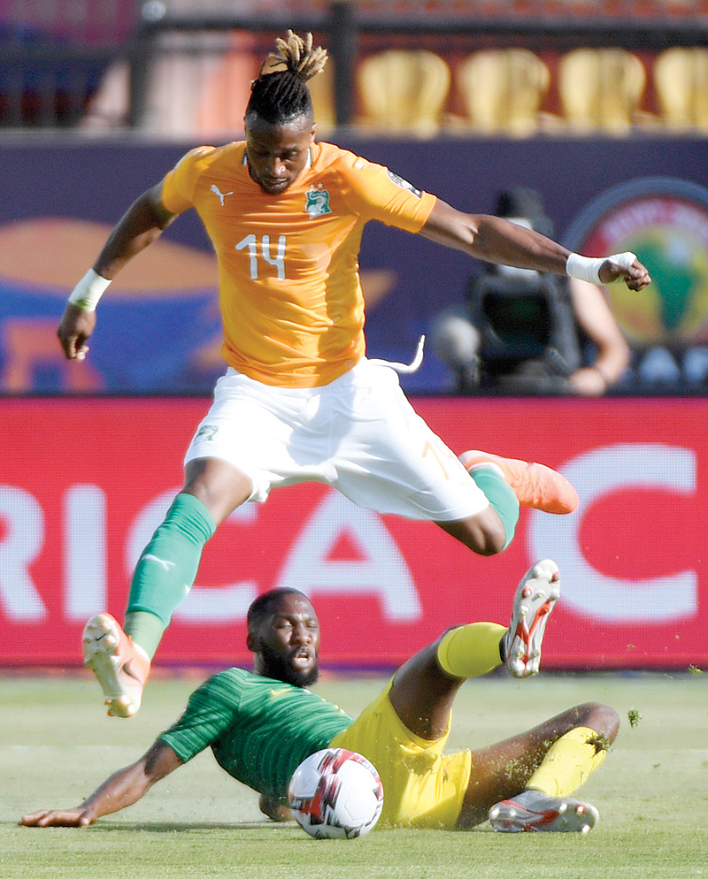 CAIRO: South Africa’s defender Buhle Mkhwanazi (bottom) tackles Ivory Coast’s forward Jonathan Kodjia during the 2019 Africa Cup of Nations (CAN) football match between Ivory Coast and South Africa yesterday. - AFP 