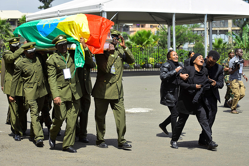 ADDIS ABABA: People mourn as members of the army carry one of the coffins covered with the Ethiopian national flag as they arrive for the National funeral service of Chief of Staff of the Ethiopian defence forces Seare Mekonnen and of Major-General Geza’e Abera, a retired former senior official in the Ethiopian army. — AFP
