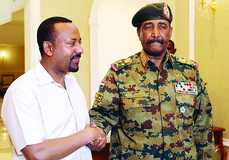 Ethiopia's Prime Minister Abiy Ahmed (L) meets with the chief of Sudan's ruling military council General Abdel Fattah al-Burhan in Khartoum on June 7, 2019. - Ethiopia's prime minister arrived in Khartoum today seeking to broker talks between the ruling generals and protesters as heavily armed paramilitaries remained deployed in some squares of the Sudanese capital after a deadly crackdown, leaving residents in 'terror'. (Photo by ASHRAF SHAZLY / AFP)