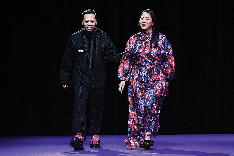 In this file photo Kenzo’s fashion designers Humberto Leon (left) and Carol Lim greet the public at the end of the show during the men’s Fall/Winter 2019/2020 collection fashion show in Paris. — AFP