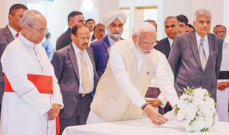 COLOMBO: Indian Prime Minister Narendra Modi pays respects to victims of the Easter Sunday attacks at St Anthony’s Church yesterday. — AFP