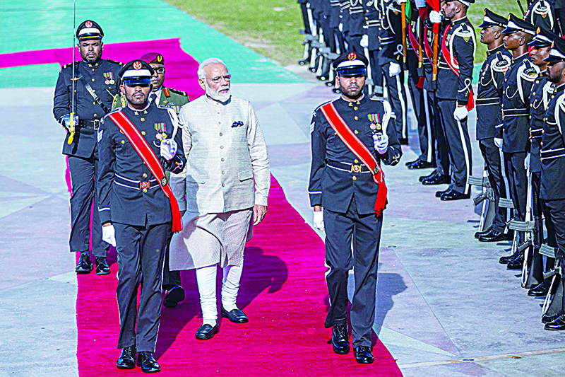 Indian Prime Minister Narendra Modi (C) inspects the guard of honour during a welcome ceremony at Republic quare in Maldive's capital Male on June 8, 2019. - Indian leader Narendra Modi inaugurated a coastal radar system and military training centre in the Maldives on June 8, as New Delhi seeks to fend off Chinese influence in the strategically-placed nation. The Maldives, a low-lying archipelago of more than a thousand tiny coral islands south of the Indian subcontinent, straddles the world's busiest east-west maritime route. (Photo by Abdulla Abeedh / AFP)