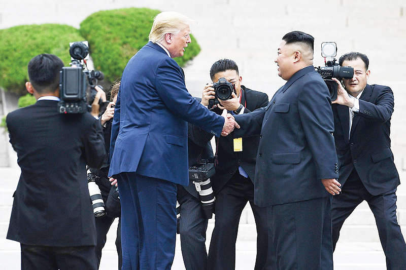 PANMUNJOM: North Korea's leader Kim Jong Un shakes hands with US President Donald Trump north of the Military Demarcation Line that divides North and South Korea in the Joint Security Area (JSA) in the Demilitarized zone (DMZ) yesterday. - AFP 