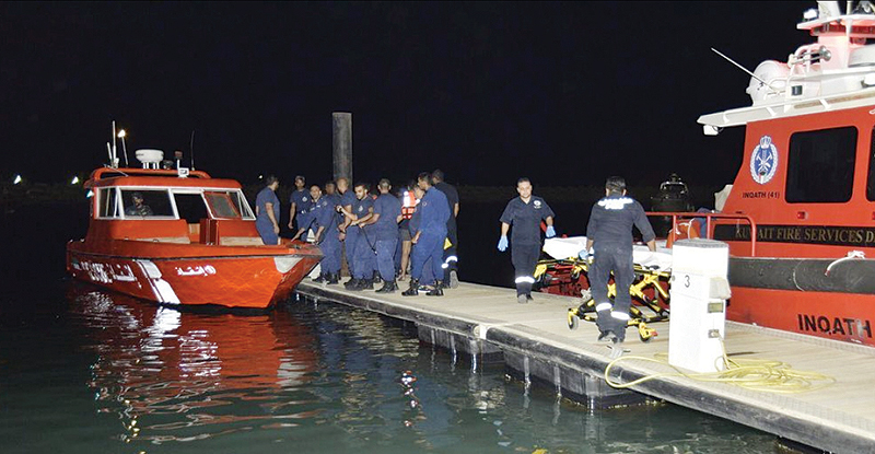 Firemen move a stretcher to help one of the men injured in the two-boat collision accident.