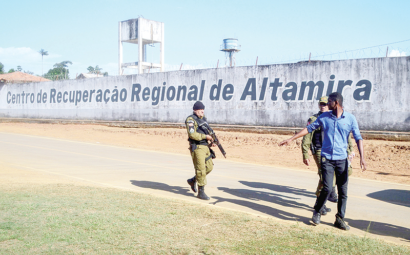 ALTAMIRA: A police officer patrols the surroundings of the Altamira Regional Recovery Centre after at least 57 inmates were killed in a prison riot, in the Brazilian northern city of Altamira, Para State, on July 29, 2019. — AFP
