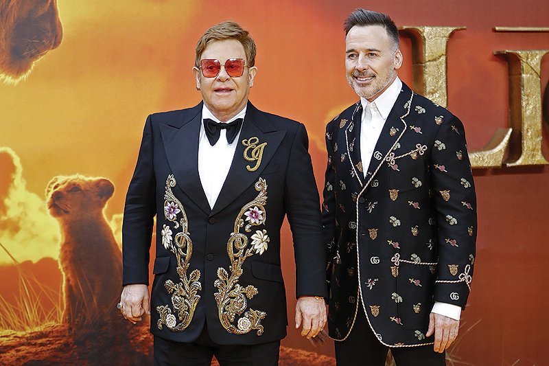 In this file photo English singer-songwriter Elton John (left) and his husband Canadian producer David Furnish (right) pose on the red carpet upon arriving for the European premiere of the film The Lion King in London.-AFP