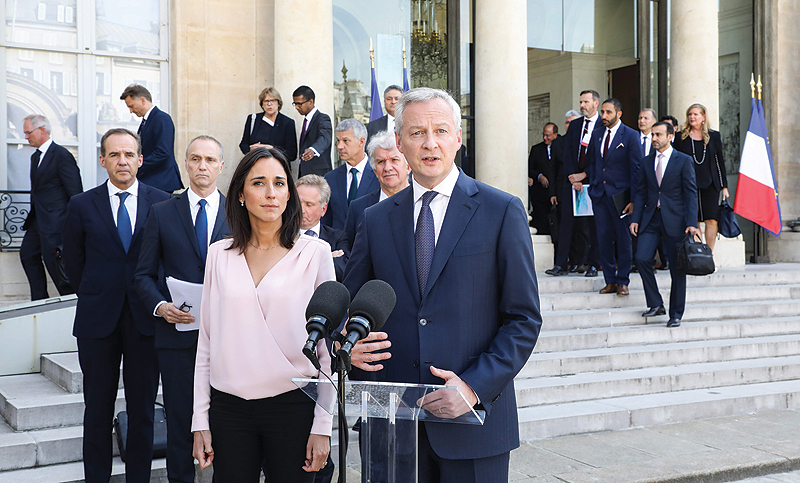 PARIS: French Economy and Finance Minister, Bruno Le Maire, right, and French Junior Minister for Environment, Brune Poirson, speak to the press after a meeting about climate action investments with heads of sovereign wealth funds and French President Emmanuel Macron, at the Elysee Palace, in Paris.—AFP
